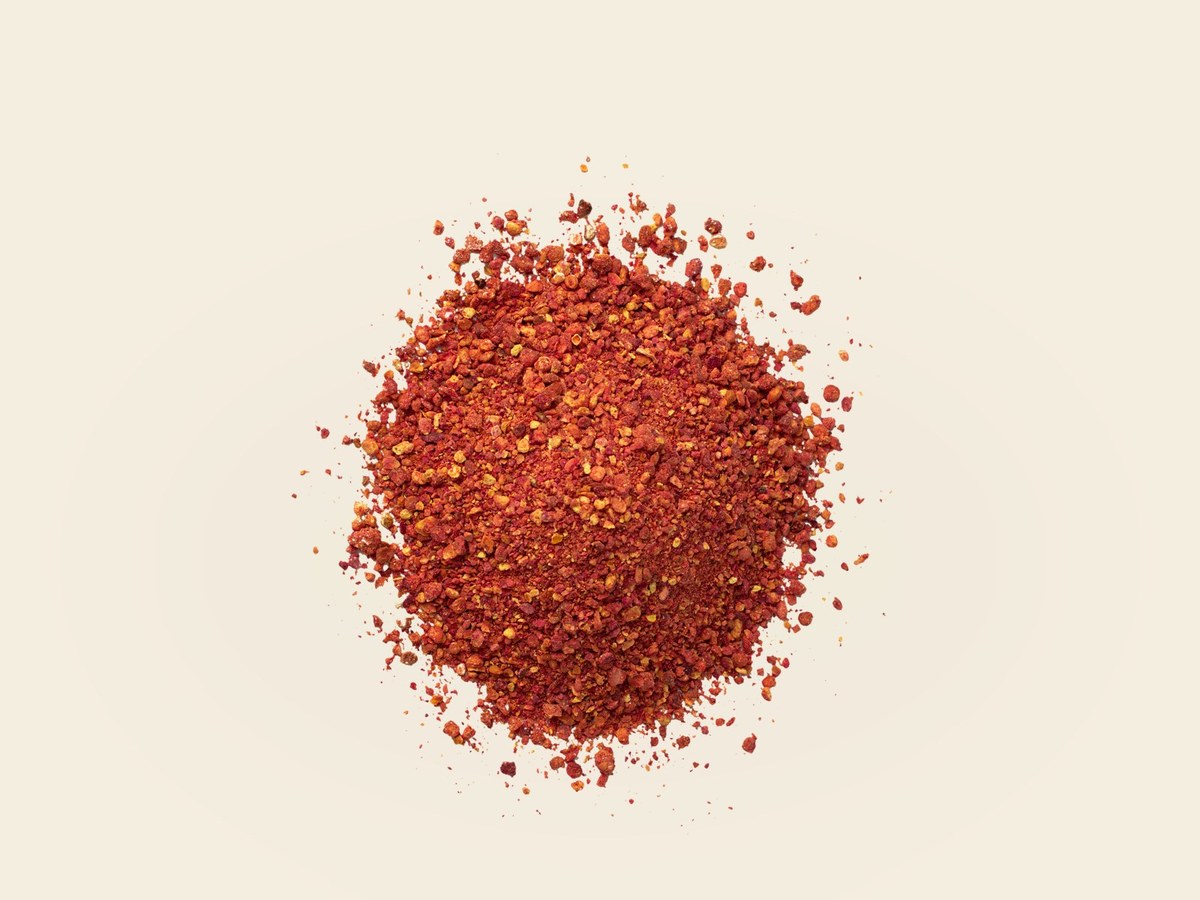 Coarse pomegranate granules in a wooden bowl
